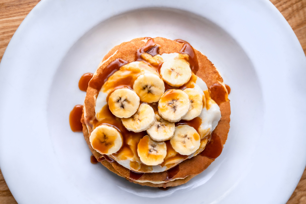 Pancakes with Slices of Bananas Topped with Syrup